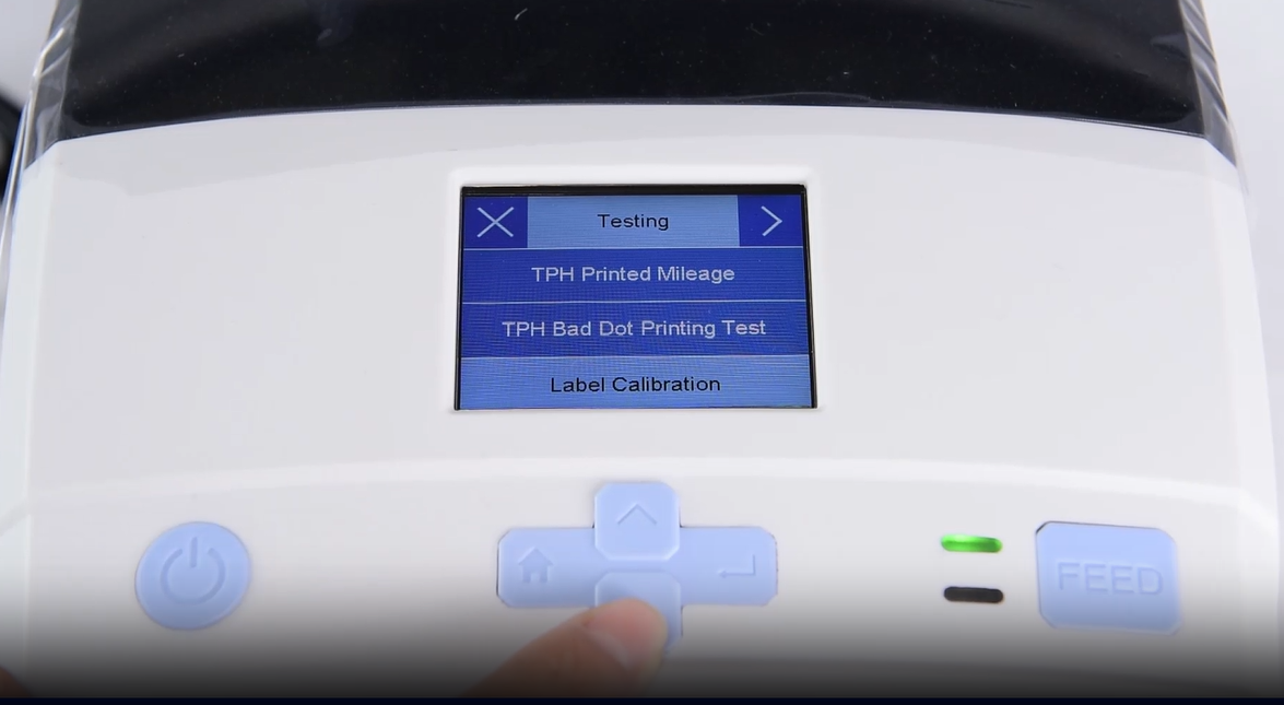 Sebuah close-up of a machine's digital interface showing a testing menu.